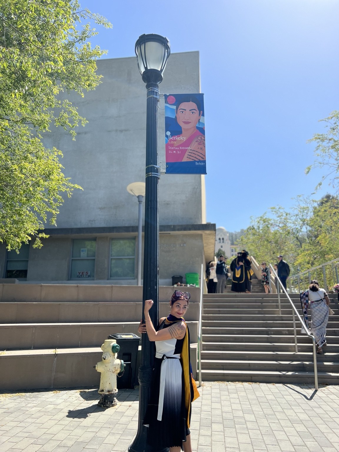 Deepika Raikwar at Berkeley Law commencement banner